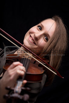happy woman playing baroque violin