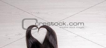 hair in shape of heart on wood