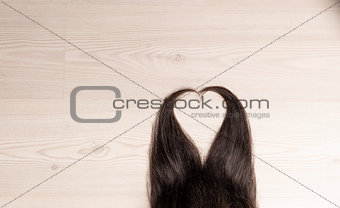 hair in shape of heart on wood