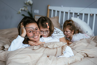 Mom and her two little cute daughters are having fun