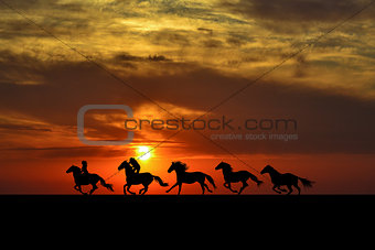 Horses galloping at sunrise