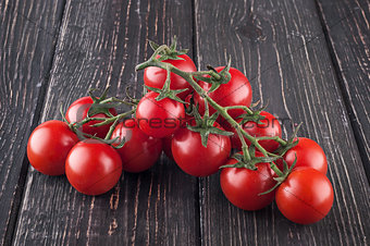 Branches cherry tomatoes on wooden table
