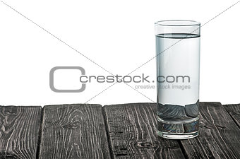 Single glass of water on wooden table
