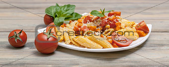 Penne pasta with vegetables, parmesan, basil leaves and cherry tomatoes. Food Banner. Mediterranean traditional cuisine