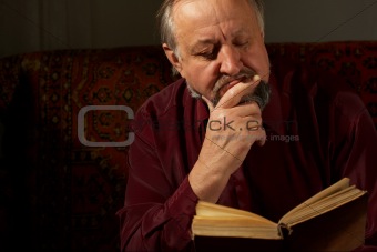 Wise man behind reading by the book