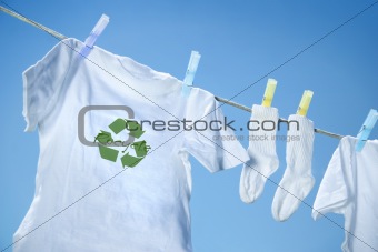 T-shirt with recycle logo drying on clothesline on a  summer day