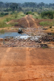 dirt track crossing a stream 