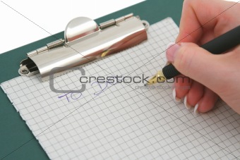 female hand writing TO DO list