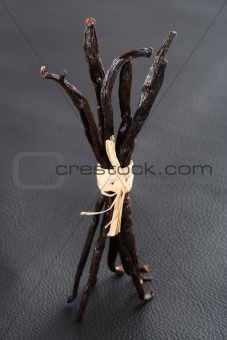 Vanilla pods bunch on black leather background