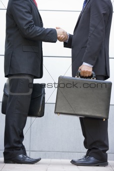 Detail of 2 businessmen meeting outside office