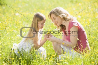 Mother and daughter in summer field