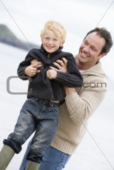 Father playing with son at beach