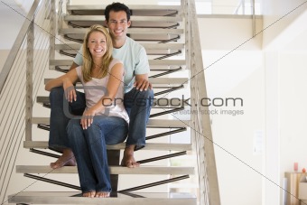 Couple at home sitting on stairs