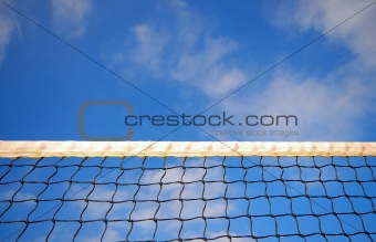 Tennis net and cloudy blue sky