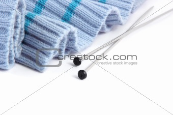 knitting needles with blue sweater