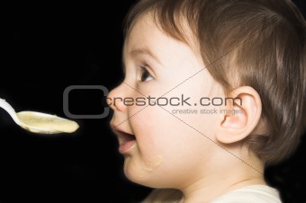 baby being fed with spoon 