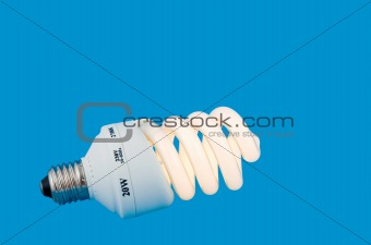 luminescent energy-saving lamp on blue background