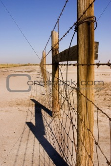 Wire and Wooden Fence Under Clear Skies