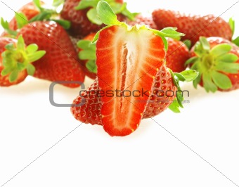 one cut fresh ripe strawberry and few as background