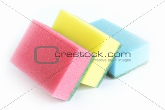 Sponges in different colors on a white surface