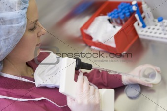 Embryologist processing sperm sample