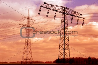 Two power poles in the sunset