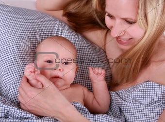 baby and mother on the bed