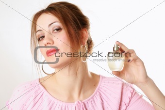 Pretty girl holding perfume