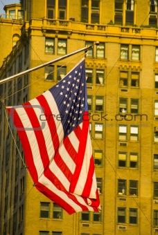 American flag and high rise building