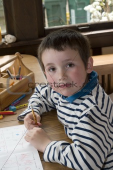 Boy doing homework at dinning table