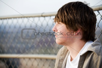 teen portrait against fence