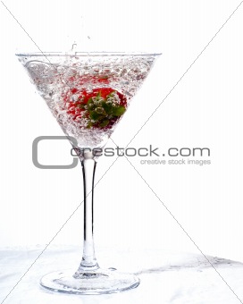 splashing wet strawberry in martini glass