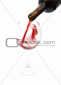 pouring red wine from a bottle