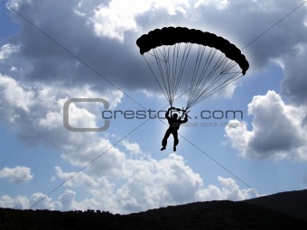 Parachutist on a cloudy sky