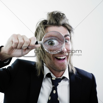 Happy man with magnifying lens