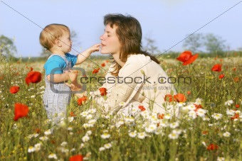 mother and son playing in flowers