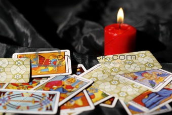 Tarot cards and burning candle