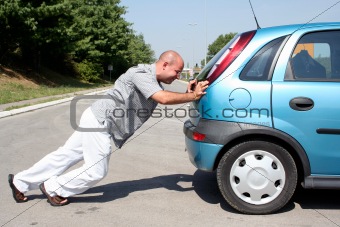 Man pushing a car