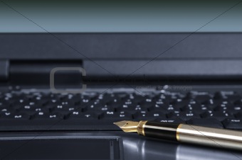 feather pen and keyboard