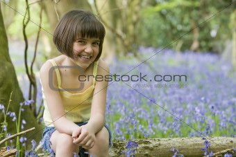girl sitting in bluebells