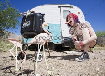 Girl in front of a trailer eating a hotdog