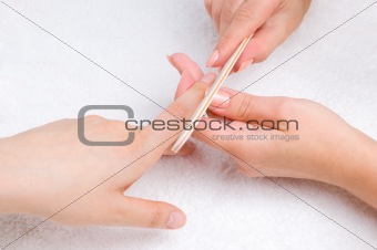 applying manicure with nail-file