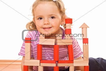 Little girl playing with wooden blocks