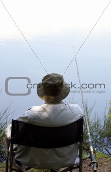 An old man enjoys fishing 