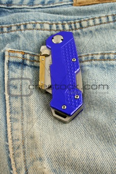 Blue anodized contractors razor knife on jeans pocket