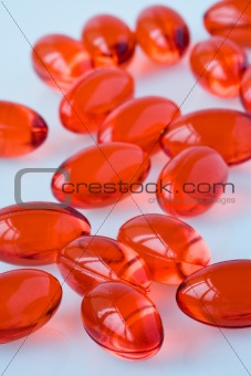 Red capsules on a white surface
