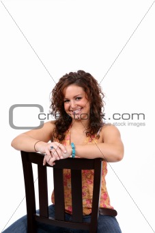 pretty teen sitting backwards in a chair