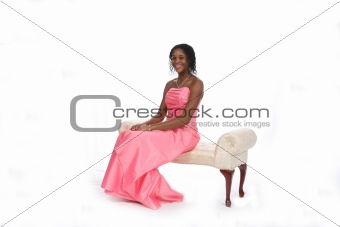 Teen in Pink Gown Sitting on Bench