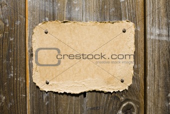 Torn Cardboard On Wooden Wall