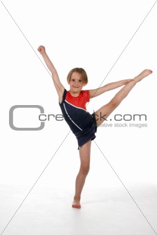 young girl balancing on one leg